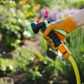 person-holding-garden-hose-with-yellow-glove-that-says-garden-it.jpg